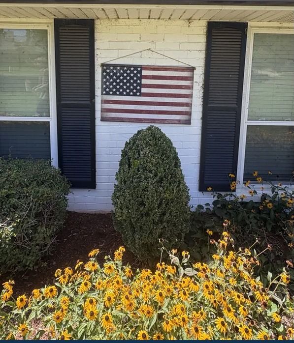 The front windows of a white brick house before cleaning